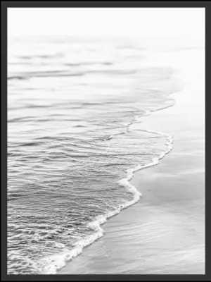 Main: Black and white photograph of gentle waves washing ashore and trailing foam across wet sand at a low angle — fine art coastal wall art digital download. Short fallback: Black and white shoreline waves wall art print.